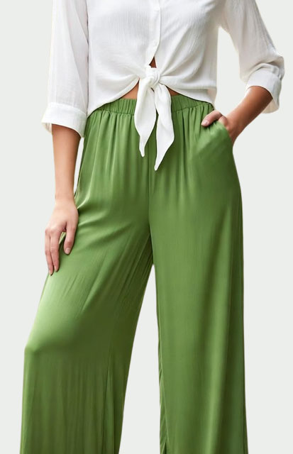 5-Silk-pants - Style Fix Studio Person wearing a white tied-front blouse with olive-green elastic-waist wide-leg pants; one hand in pocket.