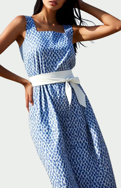 7-Casual-Dress - Style Fix Studio Model wearing a blue and white patterned sleeveless dress with a white waist sash belt.