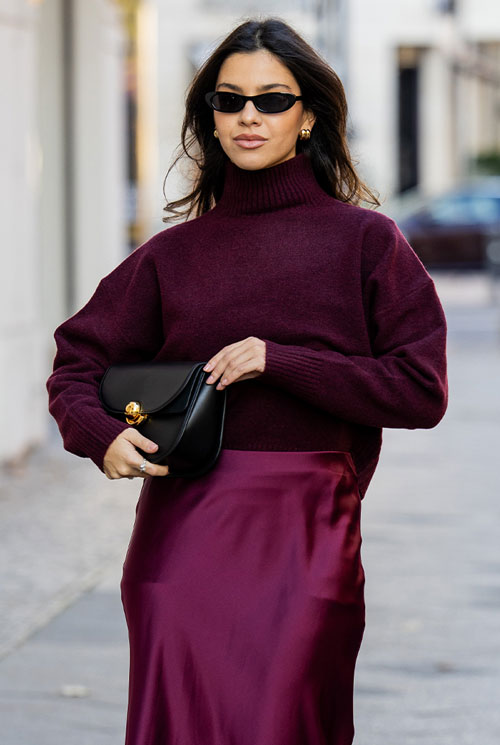 Burgundy red silk skirt paired with oxblood color sweater